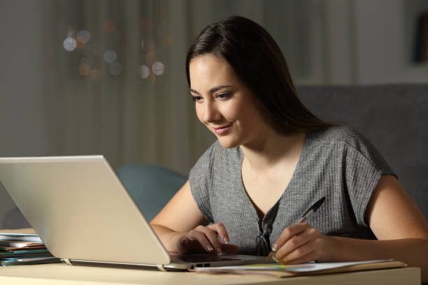Girl studying PTE online with a laptop